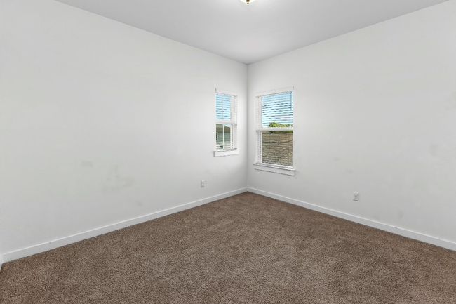 Unfurnished room featuring dark carpet and baseboards | Image 34