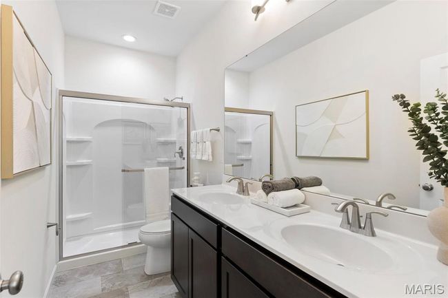 Full bathroom with toilet, a stall shower, and double vanity | Image 21
