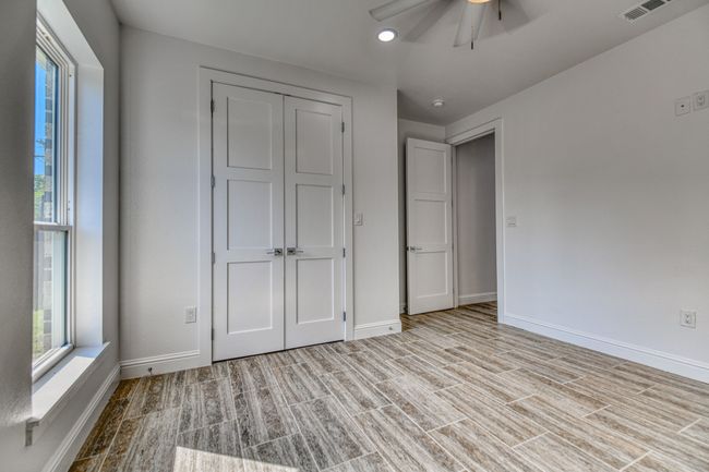 Unfurnished bedroom with a closet, ceiling fan, and light wood-type flooring | Image 12