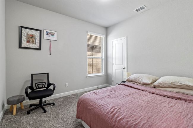 Carpeted bedroom with baseboards | Image 12