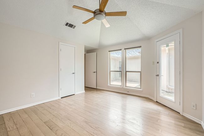 Primary Bedroom with ceiling fan, a textured ceiling, and light wood-type laminate flooring | Image 13