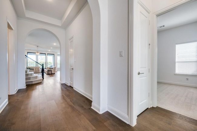 Corridor with arched walkways, stairway, and dark wood-type flooring | Image 32