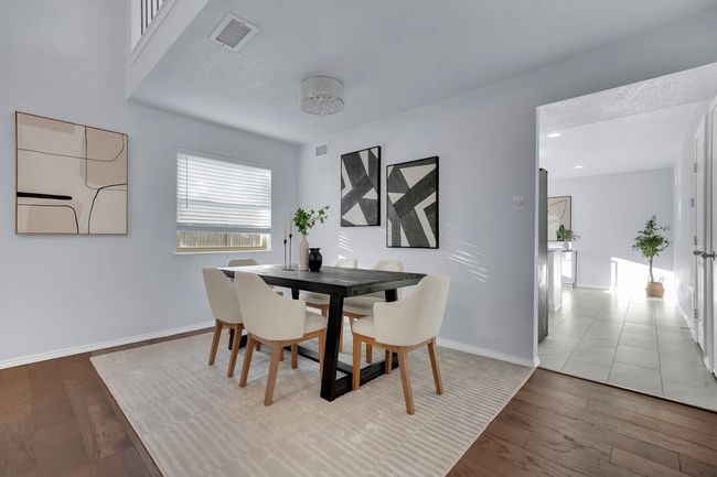 Dining space with wood finished floors and baseboards | Image 9