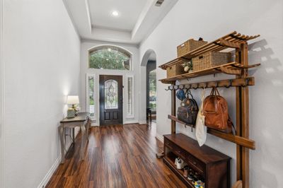 Entry with tray ceiling and access to a flexible space currently used as a dining room. | Image 3