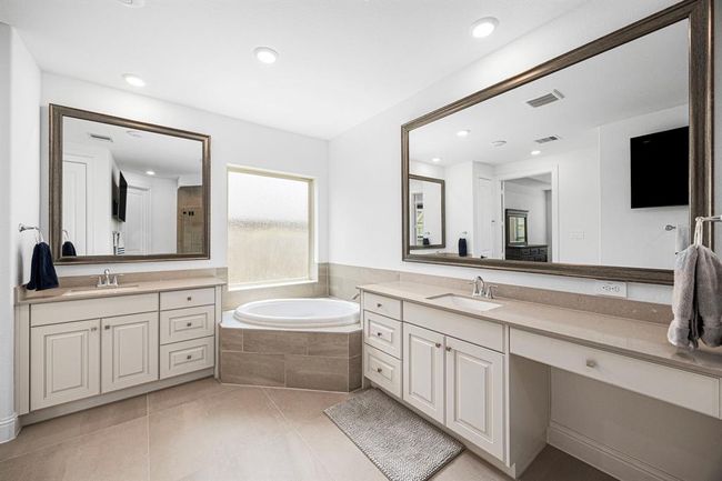 Double vanity as well as a make up table. Great counter space, cabinet space, and lighting! | Image 34