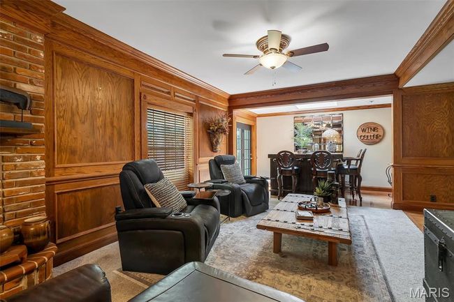 Living area with ceiling fan and ornamental molding | Image 51