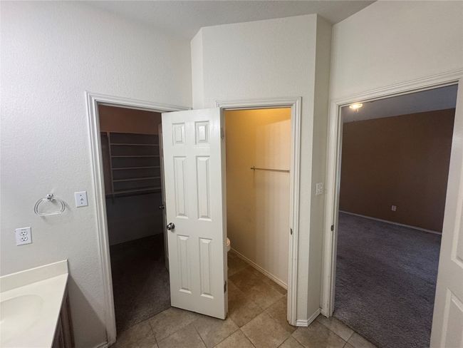 Bathroom with vanity, tile patterned flooring, and a spacious closet | Image 8