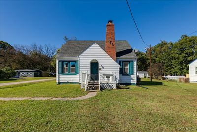 Front view of house with a lawn | Image 1