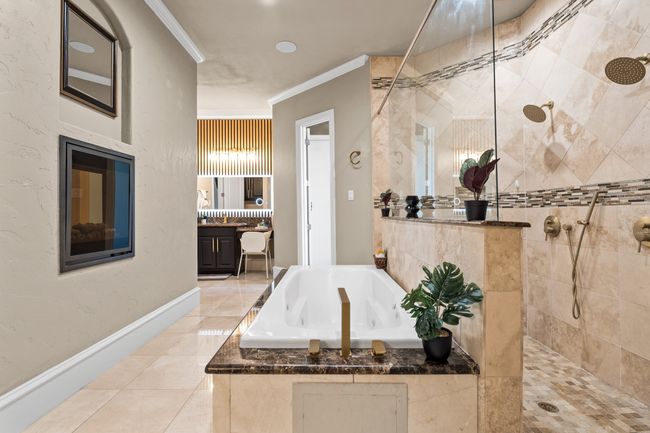 Bathroom featuring a garden tub, walk in shower, crown molding, vanity, and tile patterned flooring | Image 15