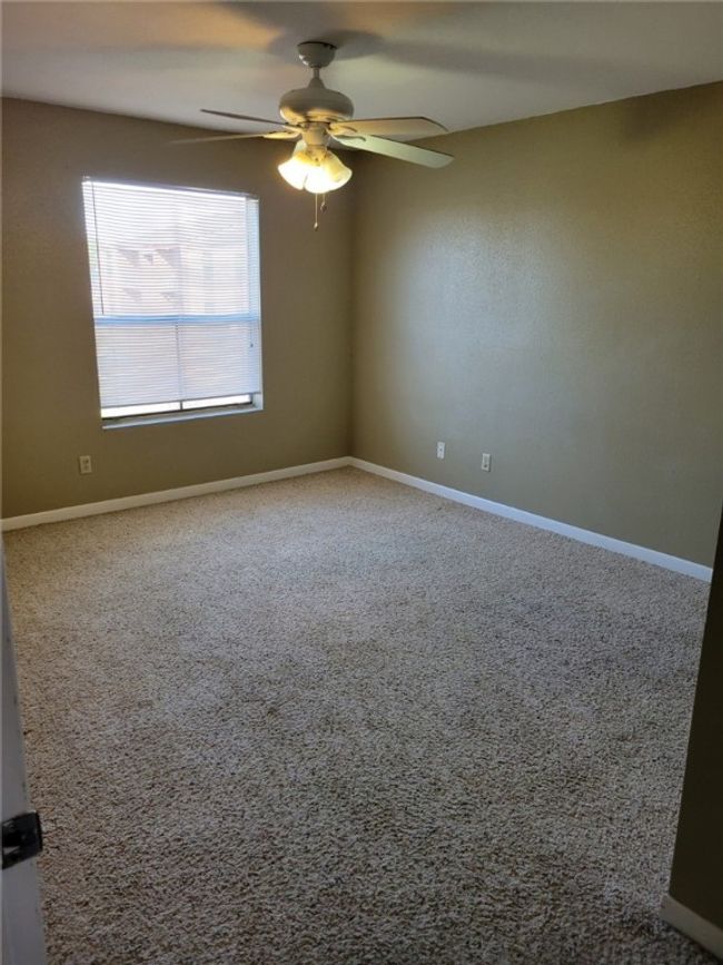 Unfurnished room with a ceiling fan and carpet floors | Image 4