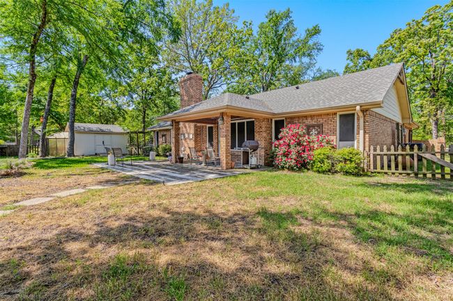 The large backyard features a covered patio area, open patio area, storage building and plenty of yard to customize according to your needs | Image 24