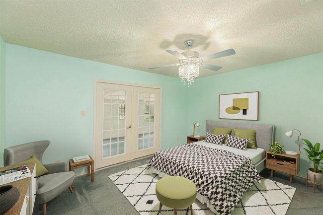 Primary bedroom with French doors out to the sun room. Virtually Staged | Image 6