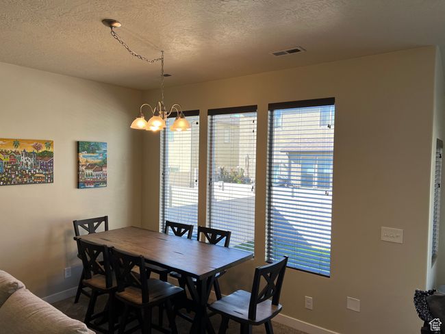 Dining space with baseboards, visible vents, a healthy amount of sunlight, and carpet | Image 9