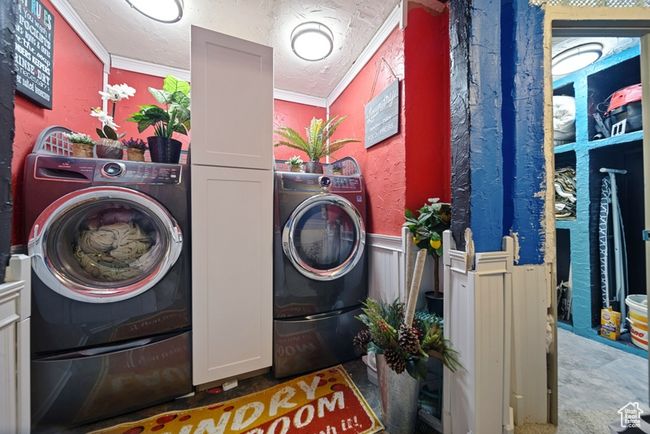 Laundry room with washer / dryer, wainscoting, cabinet space, and a textured ceiling | Image 11