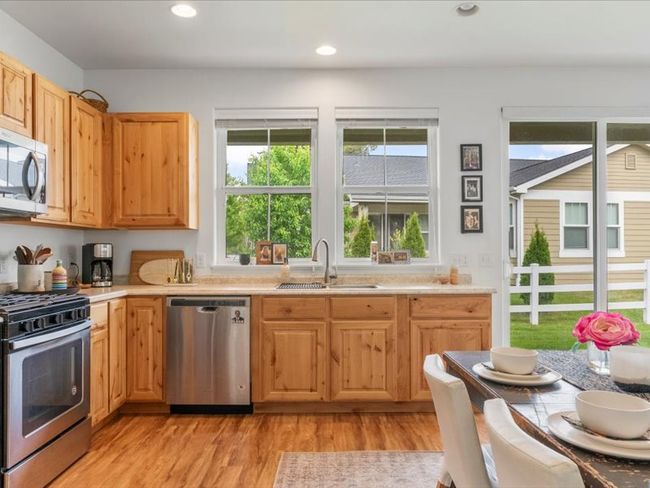 Kitchen with appliances with stainless steel finishes, healthy amount of natural light, light countertops, and recessed lighting | Image 15