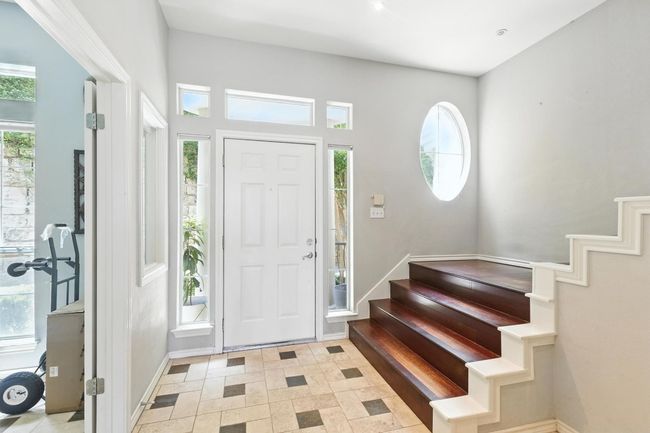 Entrance foyer featuring stairway and baseboards | Image 5