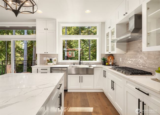 Timeless shaker cabinets paired with a sleek gas cooktop. | Image 14