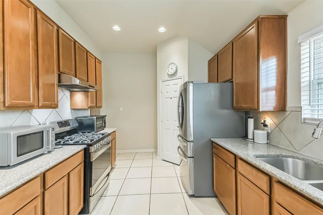 An abundance of cabinetry--offering plenty of storage space for your kitchen ware. | Image 9