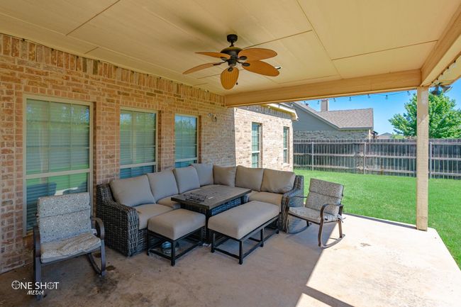 View of patio with an outdoor hangout area and ceiling fan | Image 36