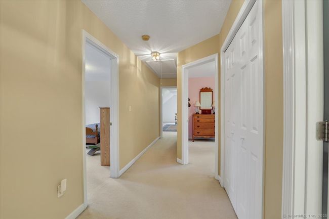Spacious second floor hallway, pull down attic stairs in ceiling. | Image 26
