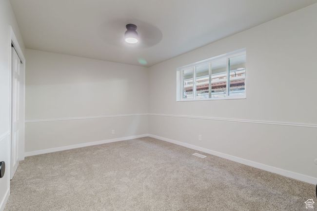 Unfurnished room with ceiling fan, carpet flooring, and baseboards | Image 12