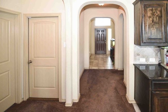 Hall featuring dark carpet and arched walkways | Image 8