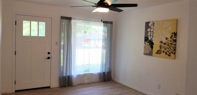 Entrance foyer with light wood-style floors, ceiling fan, and baseboards | Image 20