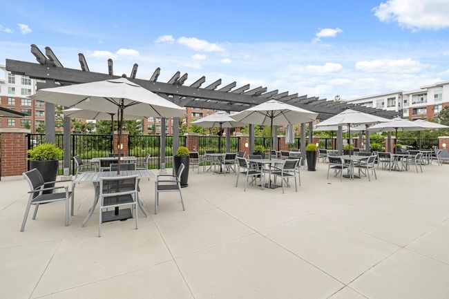 View of patio featuring fence, a pergola, and outdoor dining space | Image 37