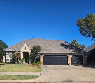 View of front facade with a front yard and a garage | Image 1