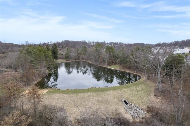 Aerial view of lake can be seen from the deck. Walking trail outside front and back door | Image 16