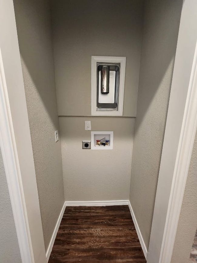 Washroom featuring hookup for an electric dryer, baseboards, washer hookup, and wood finished floors | Image 14