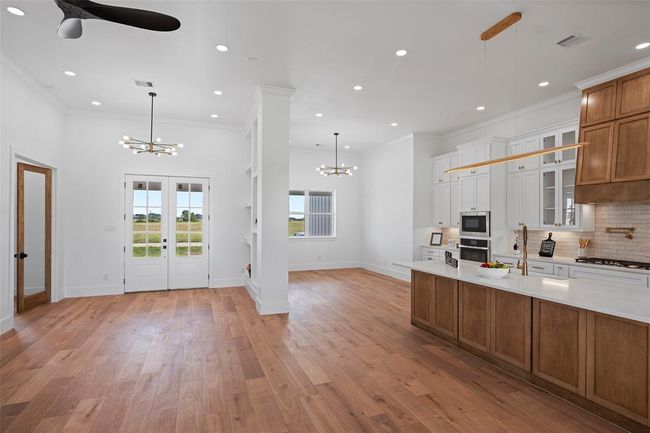 This bright and inviting office space features elegant French doors and beautiful LVP floors, perfect for productivity and inspiration. | Image 9