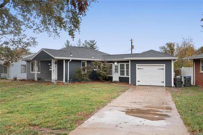 Ranch-style house with a garage and a front lawn | Image 3