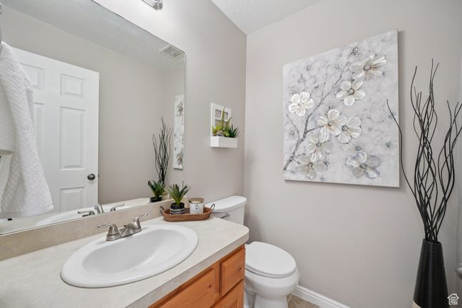 Half bathroom featuring toilet and vanity | Image 5