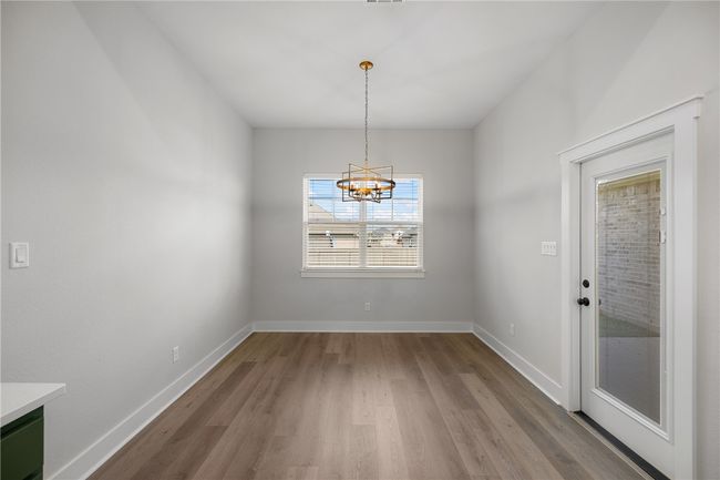 Unfurnished dining area featuring light hardwood / wood-style floors and a chandelier | Image 14