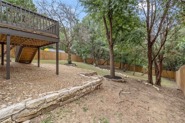 View of yard featuring a deck, stairway, and a fenced backyard | Image 35