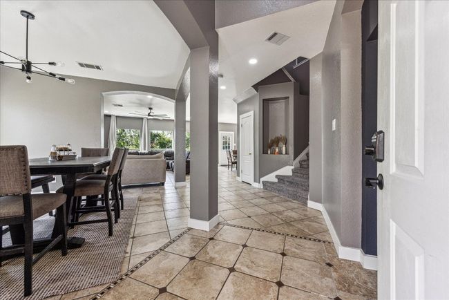 Foyer with baseboards, visible vents, and stairway | Image 4