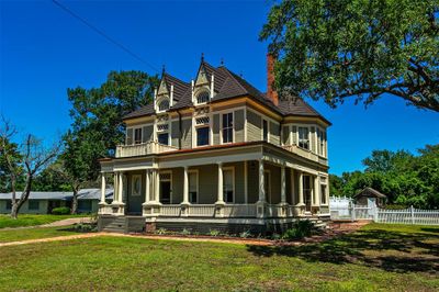 Beautiful wrap around porch on the first level. There are 3 lookout balconies on the second floor with the original walk through windows. | Image 2