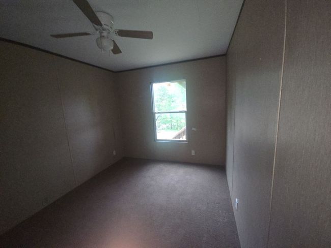 Carpeted spare room with ceiling fan | Image 15