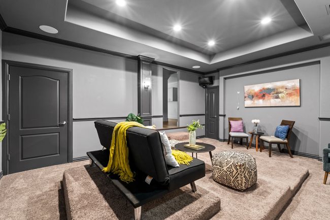 Cinema room featuring a raised ceiling, light carpet, and recessed lighting | Image 27