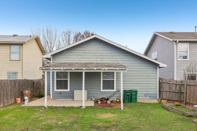 Rear view of property with fence, a yard, a patio area, and a vegetable garden | Image 18