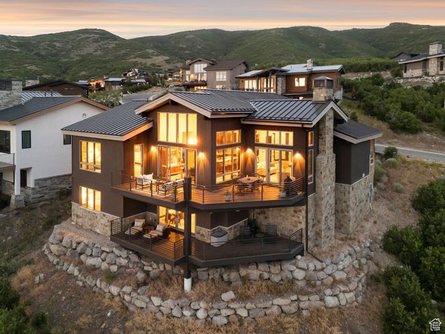 Rear view of property with stone siding, a standing seam roof, a metal roof, and a mountain view | Image 64