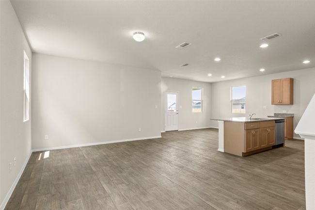 Kitchen with open floor plan, dishwasher, dark wood-style floors, recessed lighting, and light countertops | Image 9