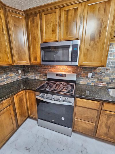 New gas range and externally vented microwave hood vent. | Image 3