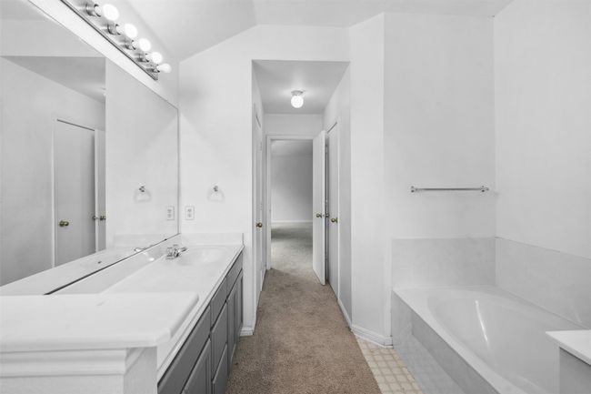 Bathroom with a sink, double vanity, and a bath | Image 22