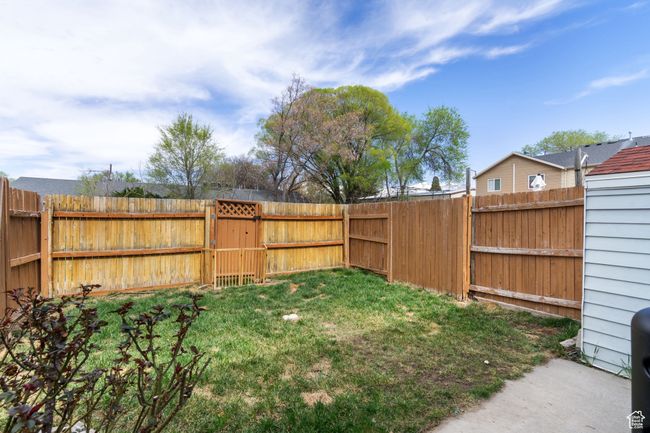 View of yard featuring a fenced backyard and a gate | Image 20