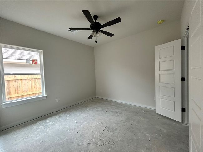 Unfurnished room with unfinished concrete flooring and ceiling fan | Image 14