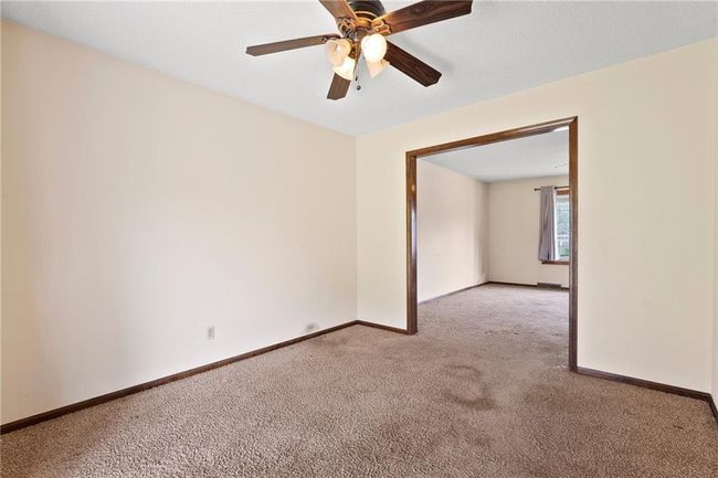 Unfurnished room with carpet, baseboards, and ceiling fan | Image 10