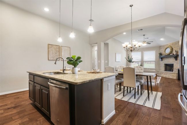 Kitchen island with views to dining area and family room | Image 8
