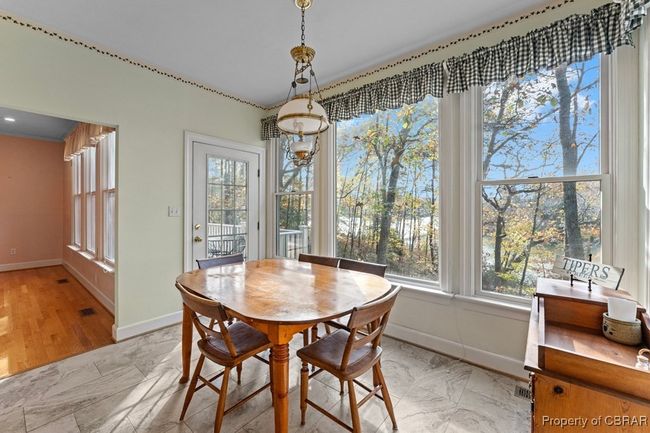 Dining space with baseboards and light marble finish floors | Image 25
